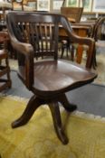 An Edwardian mahogany swivel office armchair.