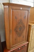 An oak hanging corner cupboard.