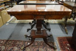 A 19th century mahogany fold over card table on column support with splay legs.