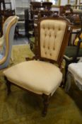 A Victorian walnut button upholstered bedroom chair.