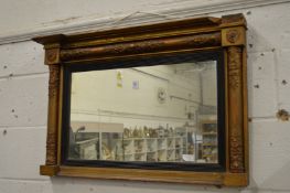 A gilt framed over mantle mirror.