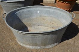 A large galvanised bath tub.