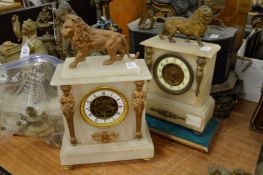 Two alabaster mantel clocks both mounted with spelter lions.
