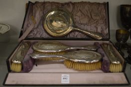 A silver backed five piece dressing table set in a fitted box (box af).
