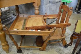 An old fashioned child’s metamorphic highchair.