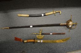 Various reproduction swords and an axe.