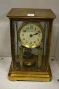 A brass four glass mantel clock.