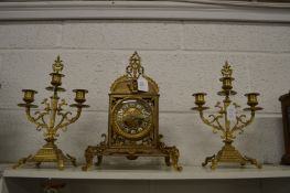 An ormolu three-piece clock garniture.