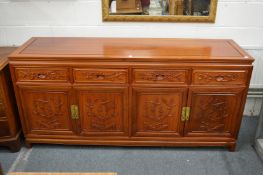 A good Chinese redwood sideboard with four drawers and four cupboard doors.