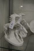A pair of Continental white porcelain figure groups of stallion and mare.