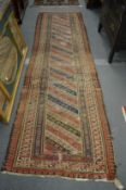 A Persian runner or hall carpet, worn 345cm x 100cm.