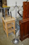 A chrome floor standing lamp with frosted glass shade.