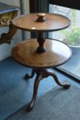 A mahogany two tier circular dumb waiter.