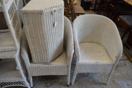 Two Lloyd loom chairs and a linen basket.