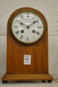 A mahogany mantle clock.