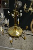 A brass six light chandelier.