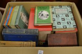 A box of children’s and other books.