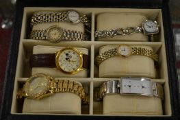 Seven ladies and gents wristwatches in a watch box.