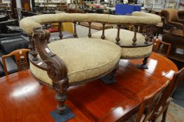A Victorian walnut framed love seat.