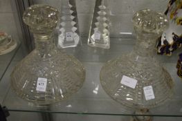 A pair of cut glass port decanters.