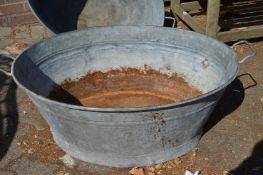A large galvanised bath tub.
