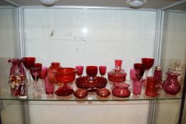 A good collection of cranberry and similar glassware.