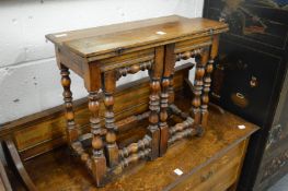 A miniature walnut gateleg table.