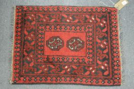 A small Persian mat 70cm x 52cm.