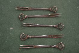 Five Chinese white metal and enamel forks.