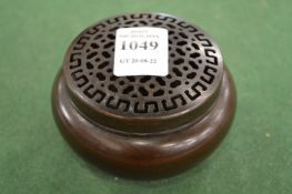 A Japanese bronze circular sensor with pierced cover.