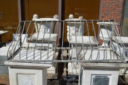 A large galvanised wrought iron hay manger.