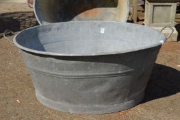 A large galvanised bath tub.