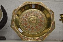 An Eastern brass, copper and silver inlaid octagonal shaped dish.