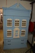An unusual pale blue painted child’s wardrobe/storage unit modelled as a Georgian town house.