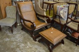 A mahogany and leather cloth upholstered armchair with matching foot stool.