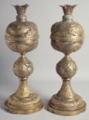 A PAIR OF PERSIAN OPENWORKED BRASS LAMPS, each with embossed and chased decoration of various panels