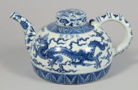 A LARGE CHINESE BLUE AND WHITE PORCELAIN TEAPOT AND COVER, the body painted with dragons, the