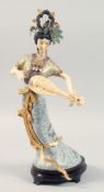 A LARGE CHINESE CLOISONNE FIGURE OF A FEMALE MUSICIAN fitted to a hardwood stand. 42cm high