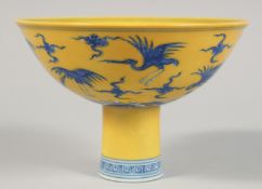 A CHINESE IMPERIAL YELLOW GROUND BLUE AND WHITE PORCELAIN STEM CUP, the exterior decorated with