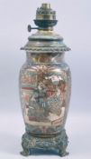 A JAPANESE SATSUMA PORCELAIN LAMP VASE with metal mounts, decorated with panels of figures,