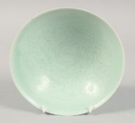 A CHINESE CELADON GLAZE BOWL, with incised decoration to the interior, 20.5cm diameter.