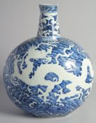 A LARGE CHINESE BLUE AND WHITE PORCELAIN MOON FLASK VASE, decorated with a large incised dragon in