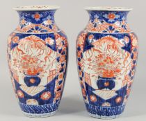A LARGE PAIR OF JAPANESE IMARI PORCELAIN VASES painted with flora and phoenix. 36cm high
