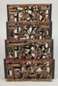 FOUR CHINESE CARVED AND PAINTED WOODEN PANELS, each panel carved and pierced with scenes of