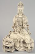 A CHINESE BLANC DE CHINE FIGURE OF GUANYIN, seated upon a lion, and holding a ruyi, with impressed