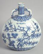 A CHINESE BLUE AND WHITE PORCELAIN MOON FLASK VASE, decorated with various blossoms, 25cm high.