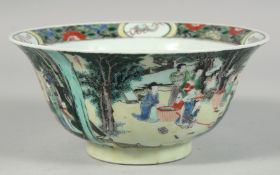 A CHINESE FAMILLE VERTE PORCELAIN BOWL, the exterior decorated with busy figures in an outdoor