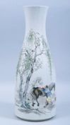 A LARGE CHINESE PORCELAIN BOTTLE VASE, painted with a figure grooming two horses beside a tree,