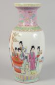 A CHINESE PINK GROUND FAMILLE ROSE PORCELAIN VASE painted with female figures in a garden, inscribed