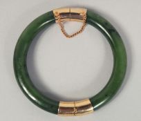 A CHINESE SPINACH JADE BANGLE, 8cm diameter.